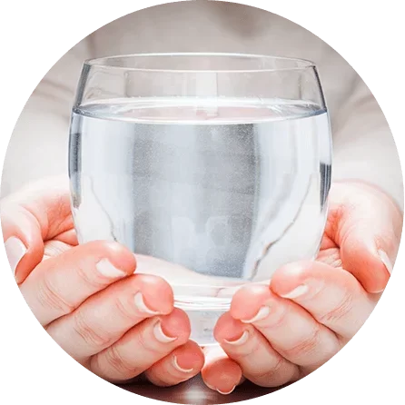 Image of two hands holding a cup of water